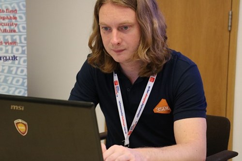 Participant working on a laptop at the cyber security challenge.